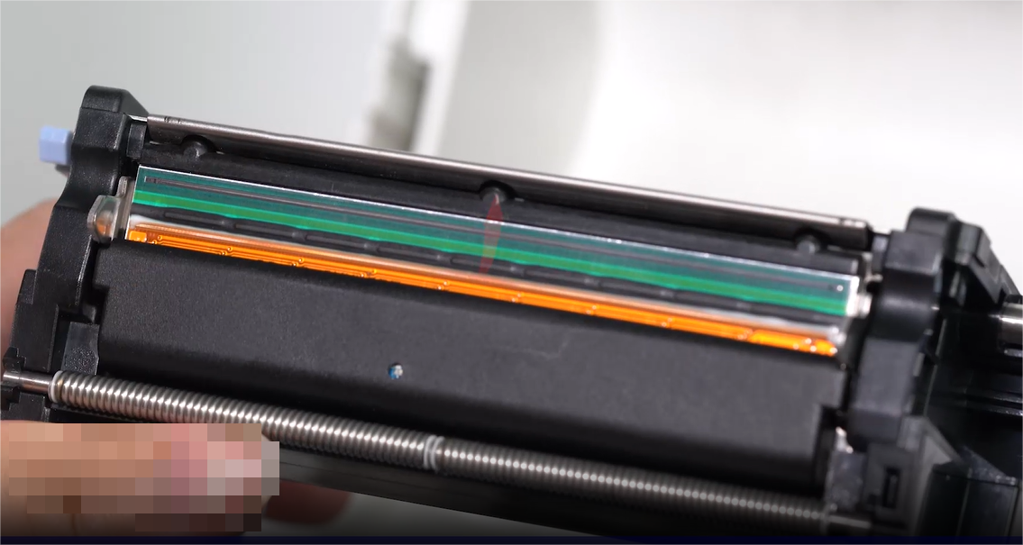 A. close-up of a person carefully cleaning an electronic component with a swab.