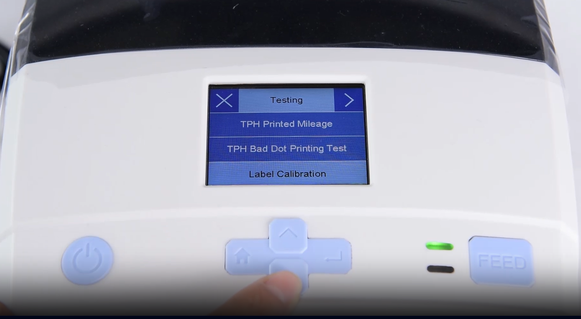 A. close-up of a machine's digital interface showing a testing menu.